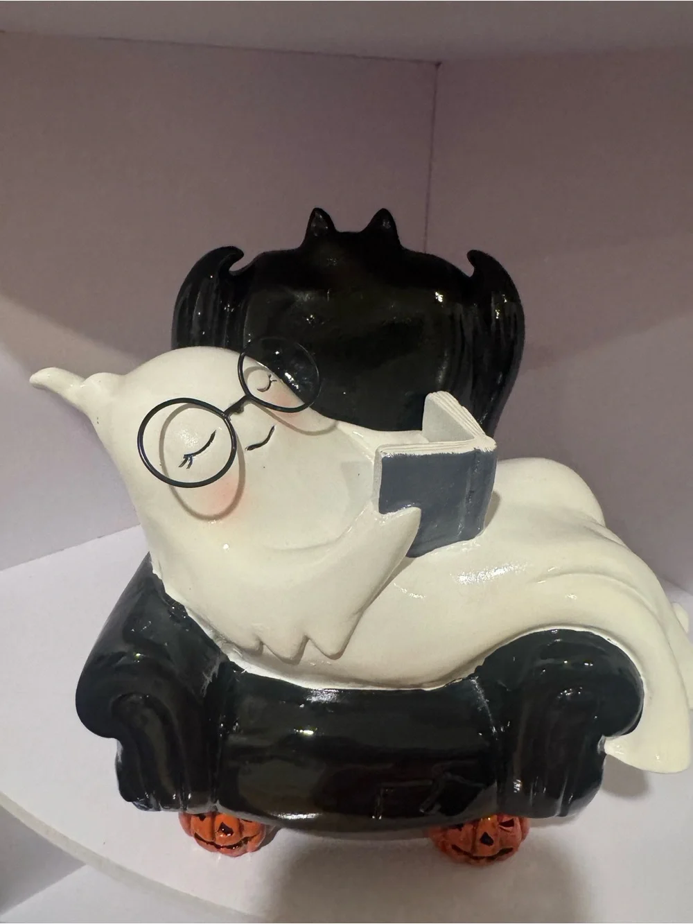 White Ghost Figurine on Black Chair Halloween Décor